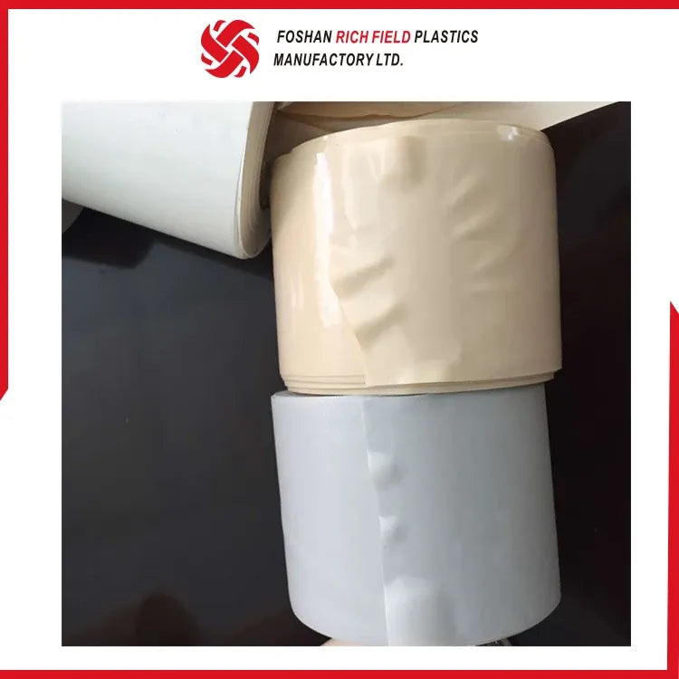 Stacked white PVC air duct tape rolls, showing the wound tape layers