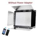 LED video light panel with reflective barn doors, remote control, and smartphone icon for wireless lighting control.