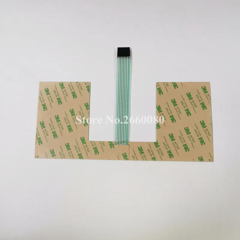 Keyboard film back sheet with green ribbon cable and printed label backing