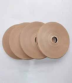 Tan hot melt glue tape rolls stacked, single-sided adhesive with center core holes