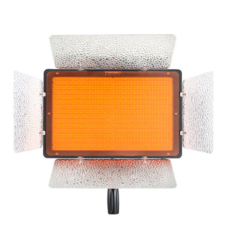 Rectangular LED video light with amber filter and four silver reflective metal barn doors for studio photography.