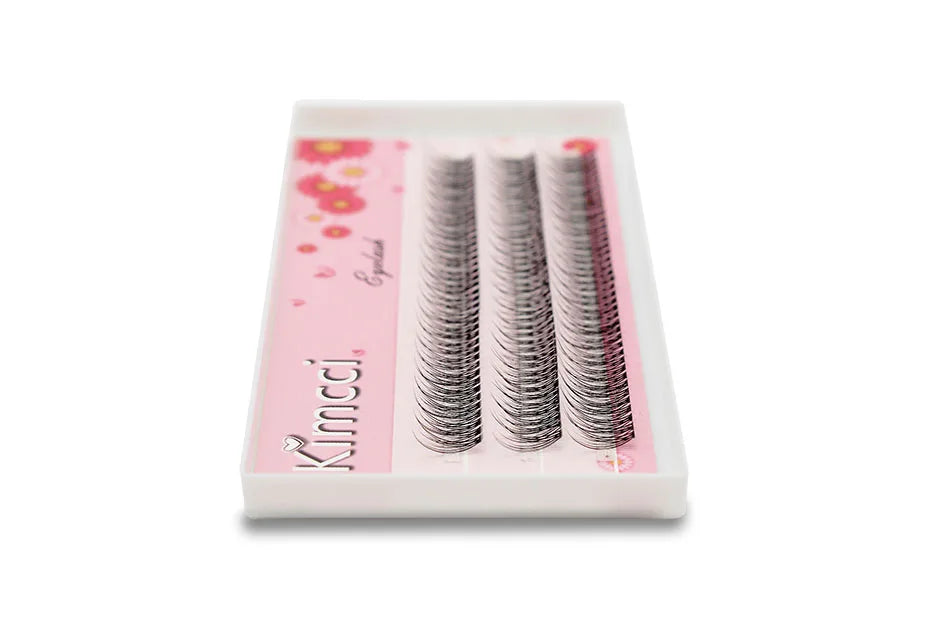 Tray of black Kimcci individual mink flared 3D cluster eyelash extensions on a floral pink background.