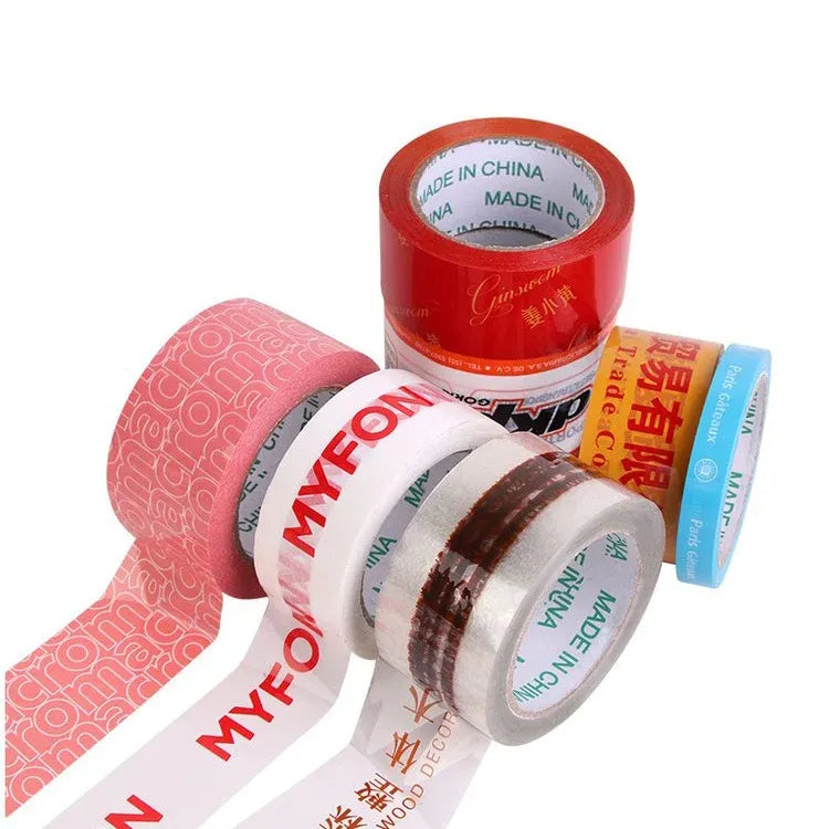 Assorted printed packing tape rolls with red, blue, and white patterned lettering