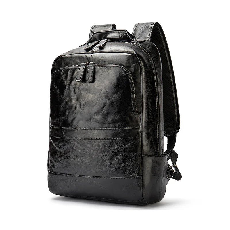 Black genuine leather designer backpack with textured finish, multiple zippered compartments, and adjustable straps.
