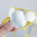 Silver circular seal sticker reading “CHINLLAGE” and “facial club”