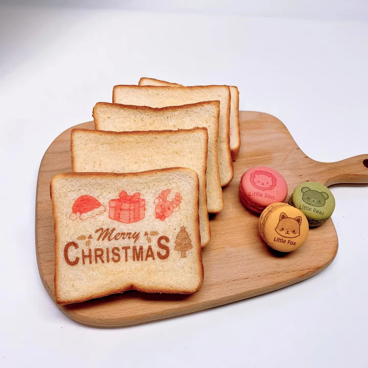 Edible ink printed Christmas toast slices on a wooden serving board