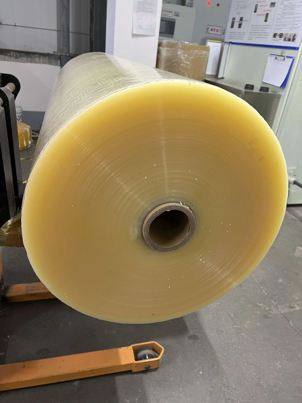BOPP adhesive tape jumbo roll, yellow tape wound around a hollow core