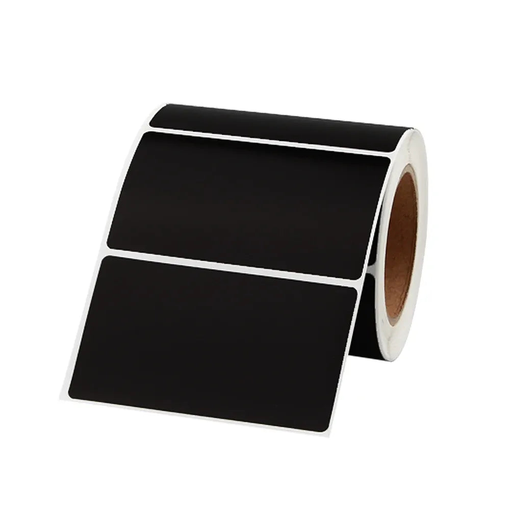 Black thermal label roll with two blank rectangular labels on a dispensing reel