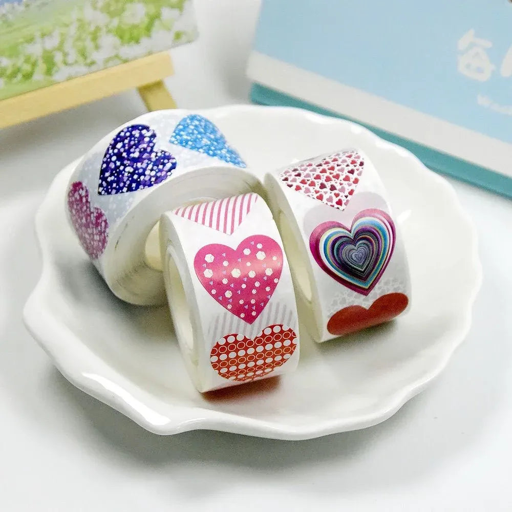 Self-adhesive heart sticker roll with blue and pink heart shapes on a plate