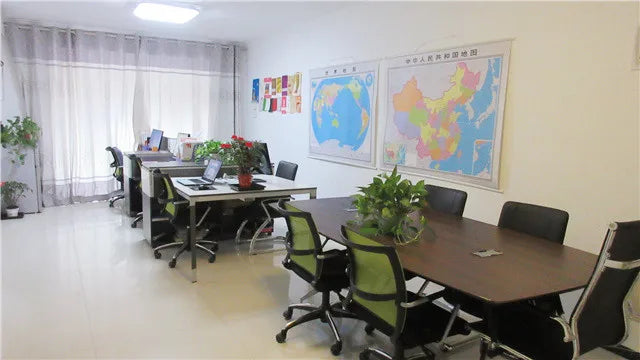 Office meeting room with desks, chairs, and wall maps