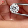 Round brilliant-cut lab-grown diamond held in tweezers, close-up view