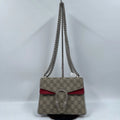 Pre-owned designer shoulder bag in beige monogram canvas with red leather trim and silver chain strap.