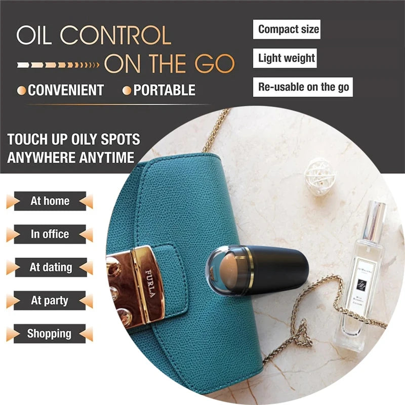 A black volcanic stone oil-absorbing roller with a clear cap, placed on a teal purse next to a perfume bottle.