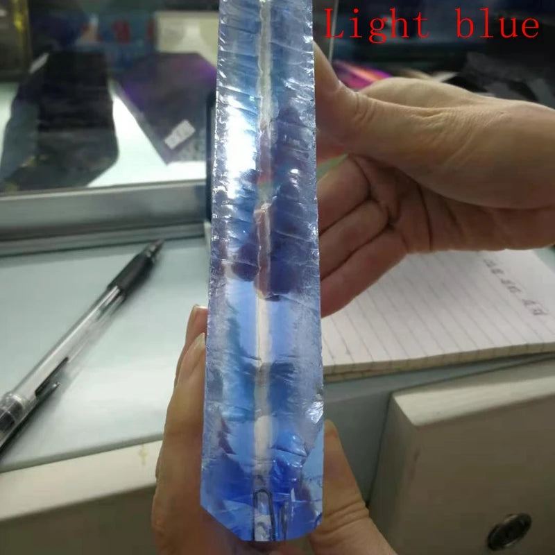 Light blue synthetic hydrothermal crystal prism, close-up of smooth side surface.