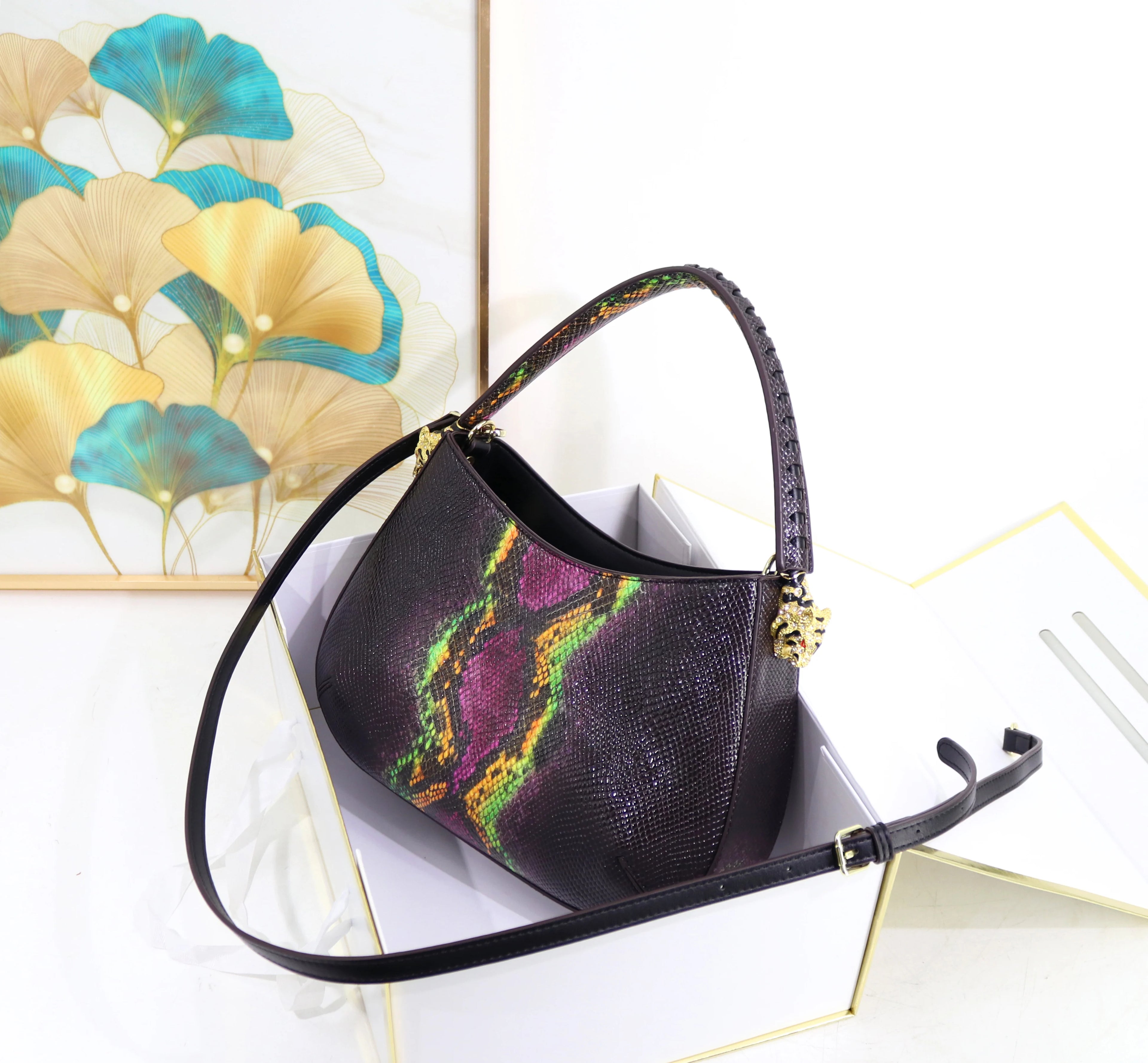 32cm designer shoulder bag with purple and green snakeskin print, gold hardware, and textured leather finish.