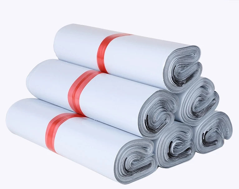 Rolled plastic mailing bags, light gray, stacked with red bands