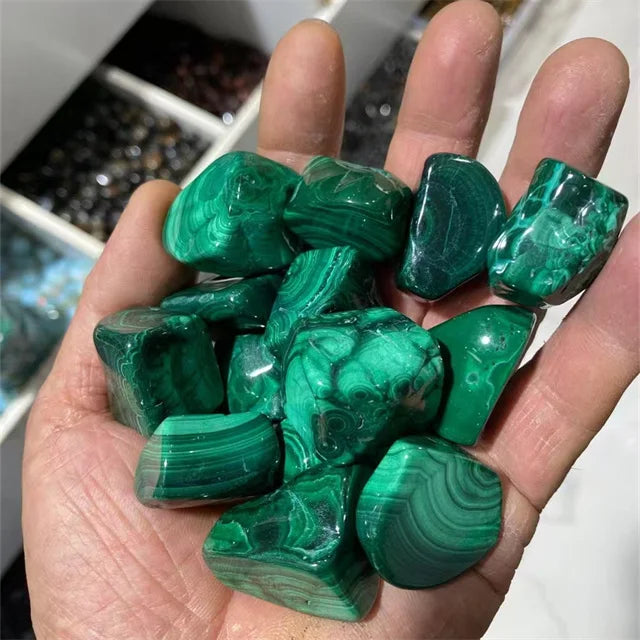 Green malachite tumbled stones, rounded shapes with banded swirl detail