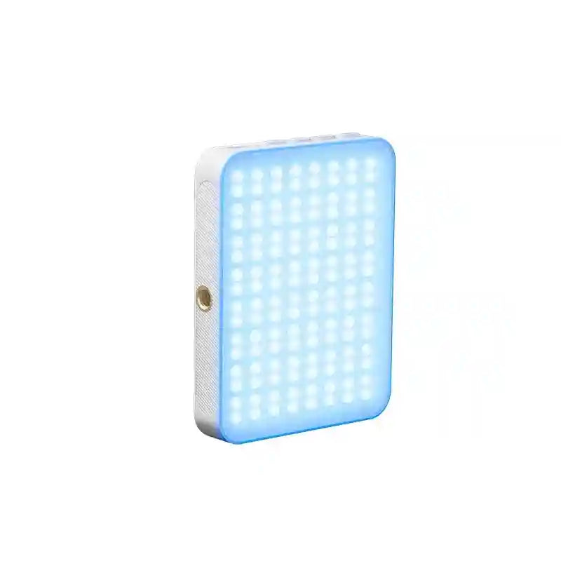 Rectangular LED video light with white casing and glowing blue panel, featuring a side screw mount for camera use.