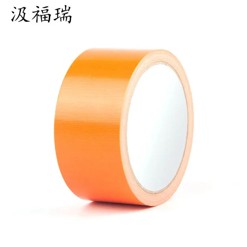 Orange waterproof adhesive tape roll on a light core