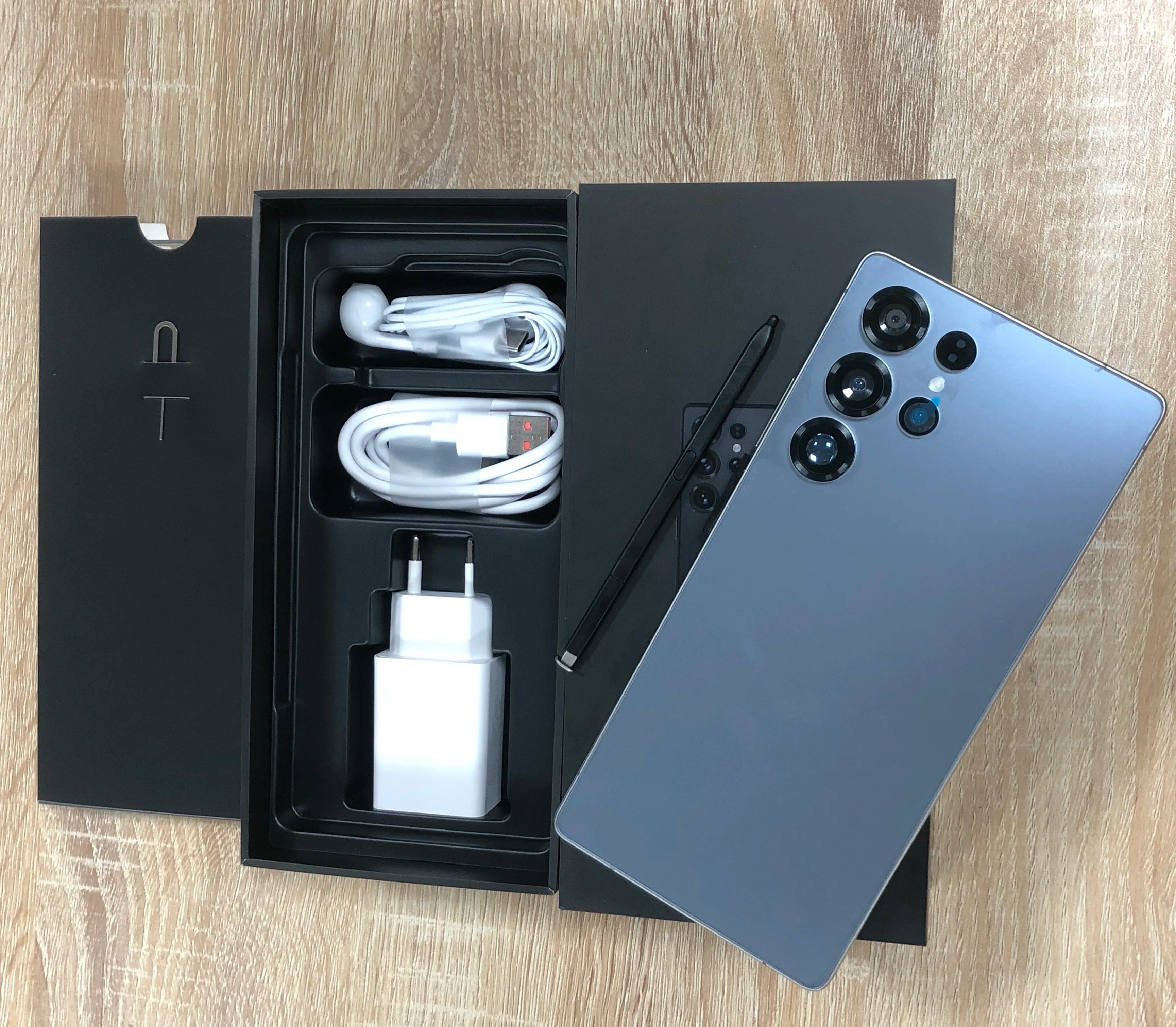 7.3-inch Android smartphone unboxed set with USB cable, charger, and rear camera panel