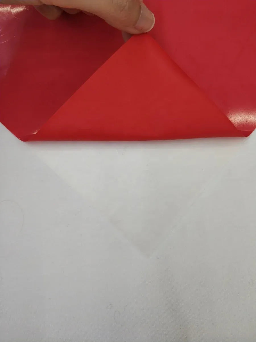 Red self-adhesive sticker sheet with protective backing