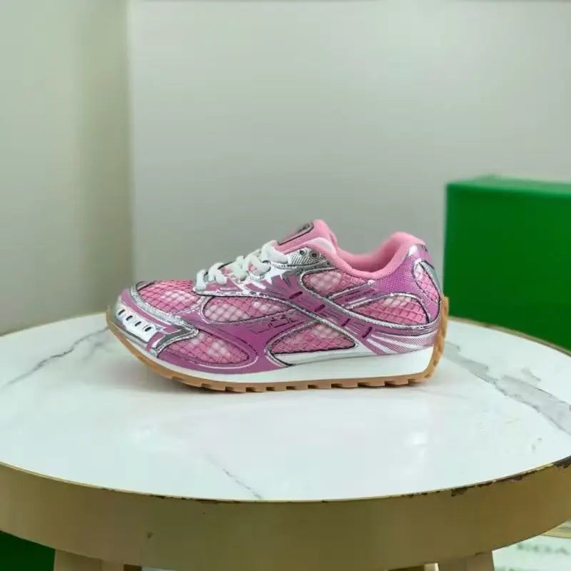 Luxury pink leather sneakers with metallic silver accents, mesh detailing, white laces, and a gum-rubber tread sole.