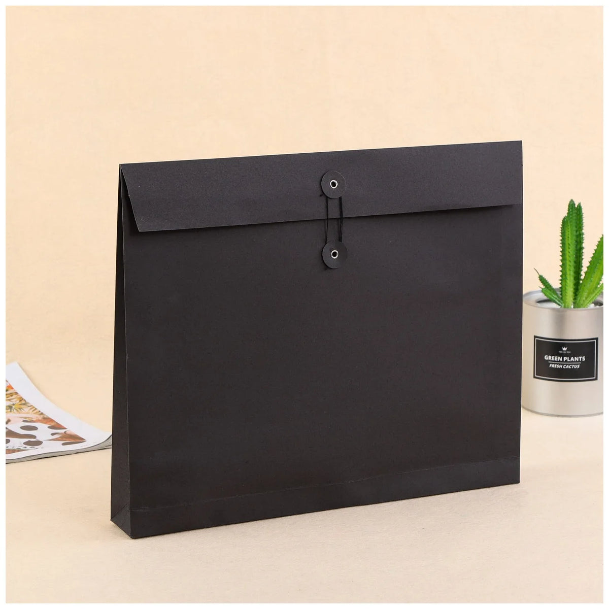 Black expandable kraft paper mailer with two eyelet closure on flap