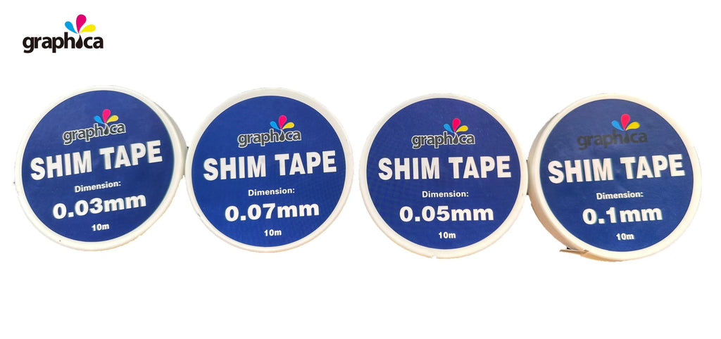 Set of white shim tape rolls showing thickness labels: 0.1mm, 0.05mm, 0.07mm, 0.03mm