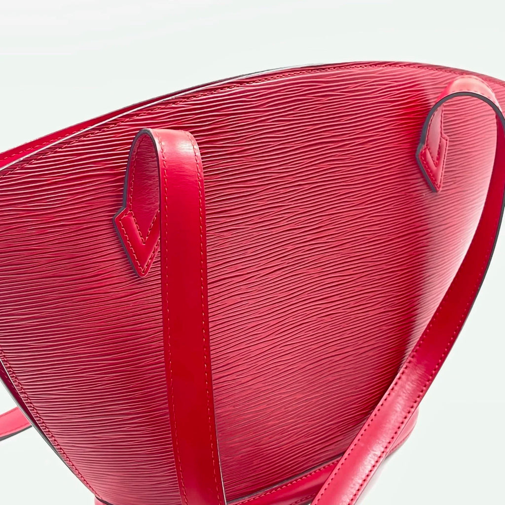Luxury red genuine leather designer shoulder bag with a classic water ripple texture and minimalist strap detail.