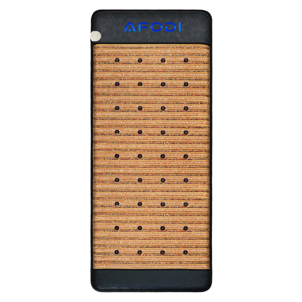 Rectangular heated crystal therapy mat with black leather edges and small, embedded dark stones for body relief.