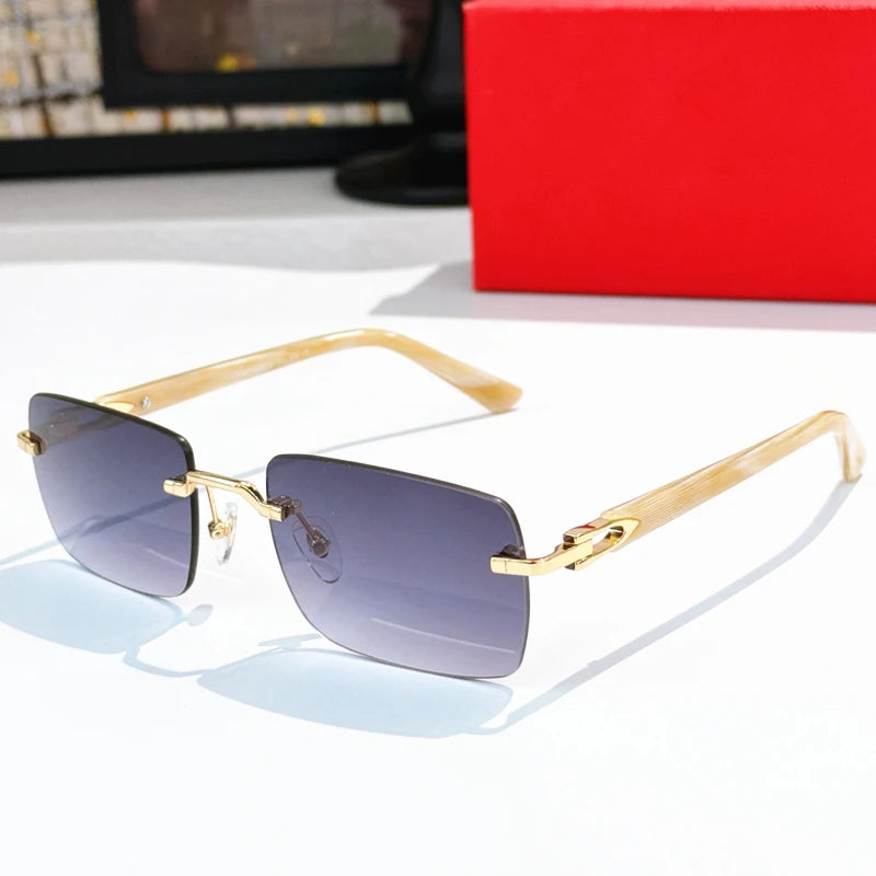 Luxury rimless rectangular sunglasses, gold titanium frame, cream acetate temples, gradient grey lenses.