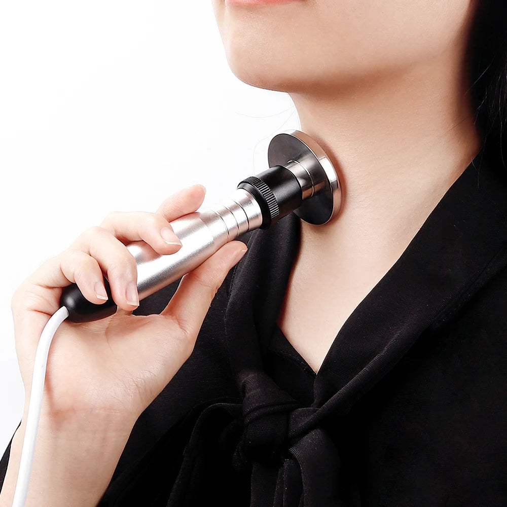 A person uses a silver and black RF skin-lifting device on their neck.