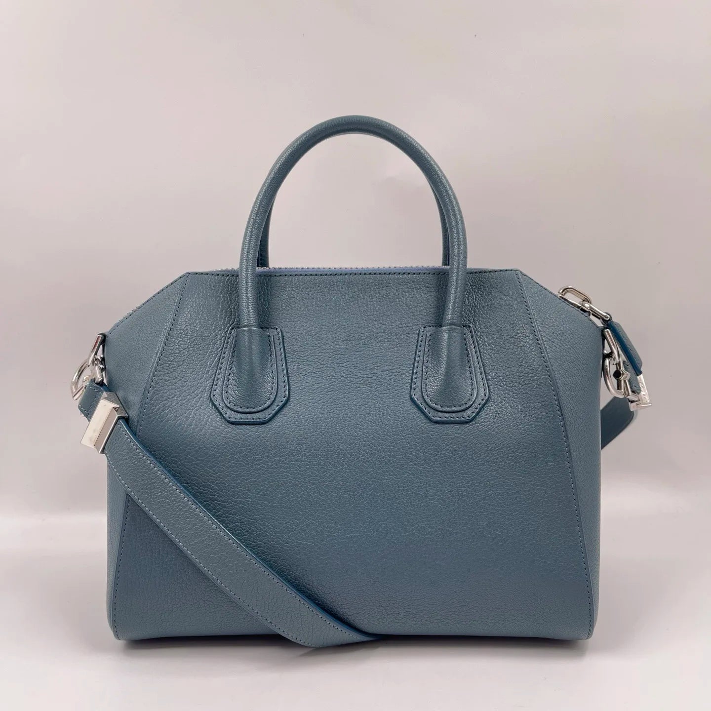 Luxury blue genuine leather designer tote crossbody bag with silver hardware and structured classic silhouette.