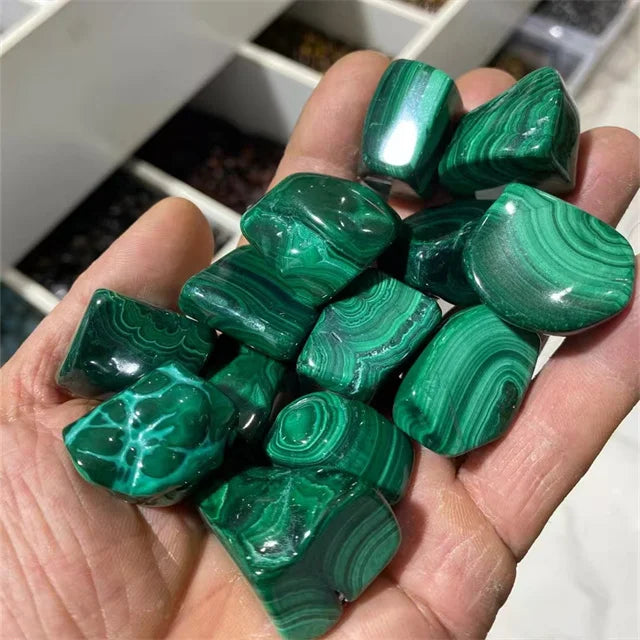 Mixed green malachite tumbled stones with glossy surface and concentric patterns