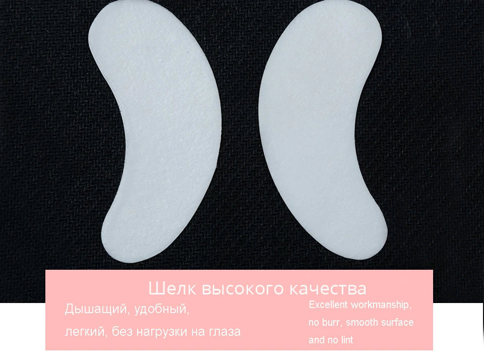 White lint-free eyelash extension pads for eye isolation during grafting on a black background. Smooth, curved design.