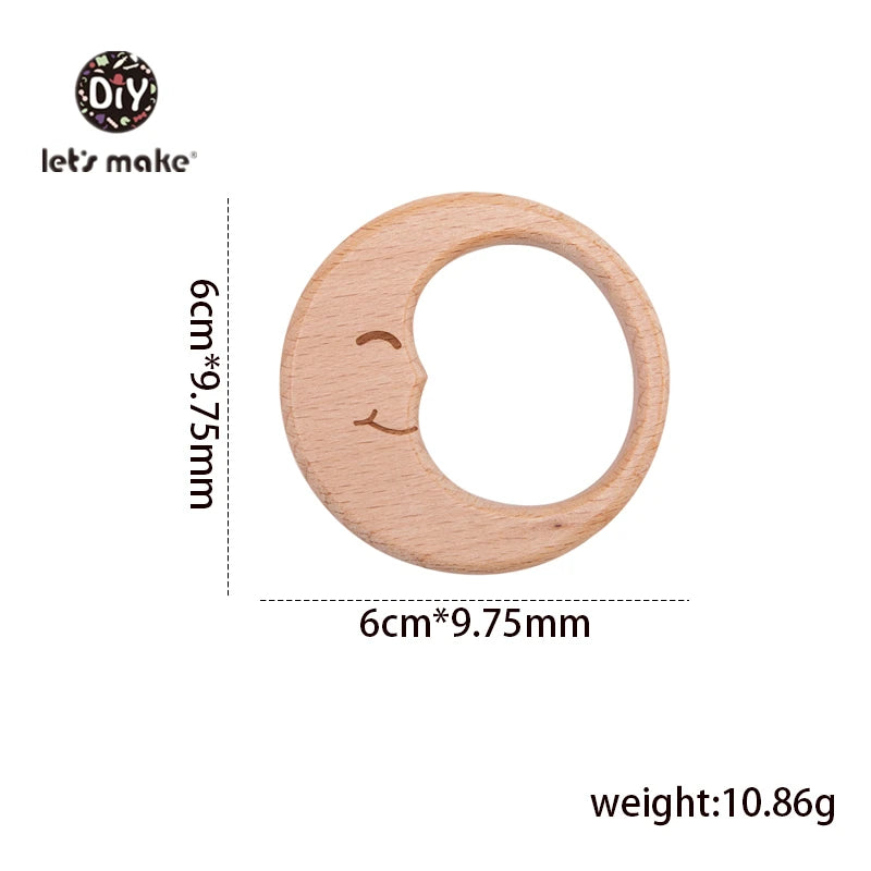 Natural wood moon baby teething ring in light beige for infant teething relief.