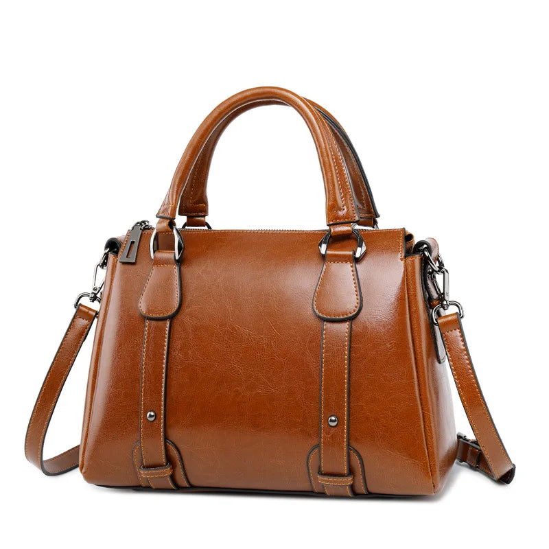 Brown genuine cow split leather designer satchel with top handles, shoulder strap, and polished metal hardware.