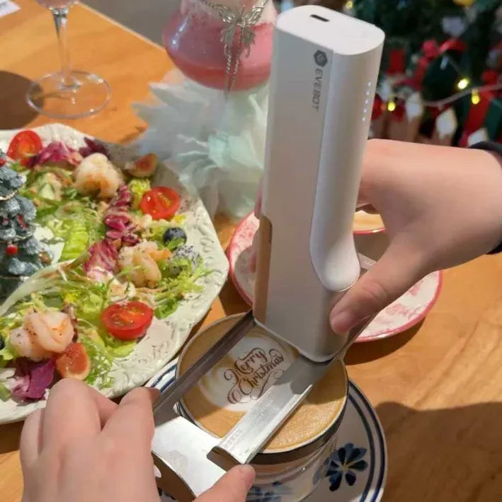 Handheld edible ink printer in white, held over a pizza with fresh print