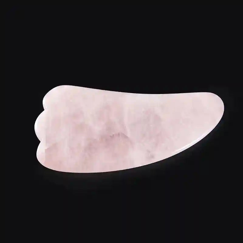 Light pink rose quartz Gua Sha facial massage tool with a smooth, wing-shaped design on a black background.