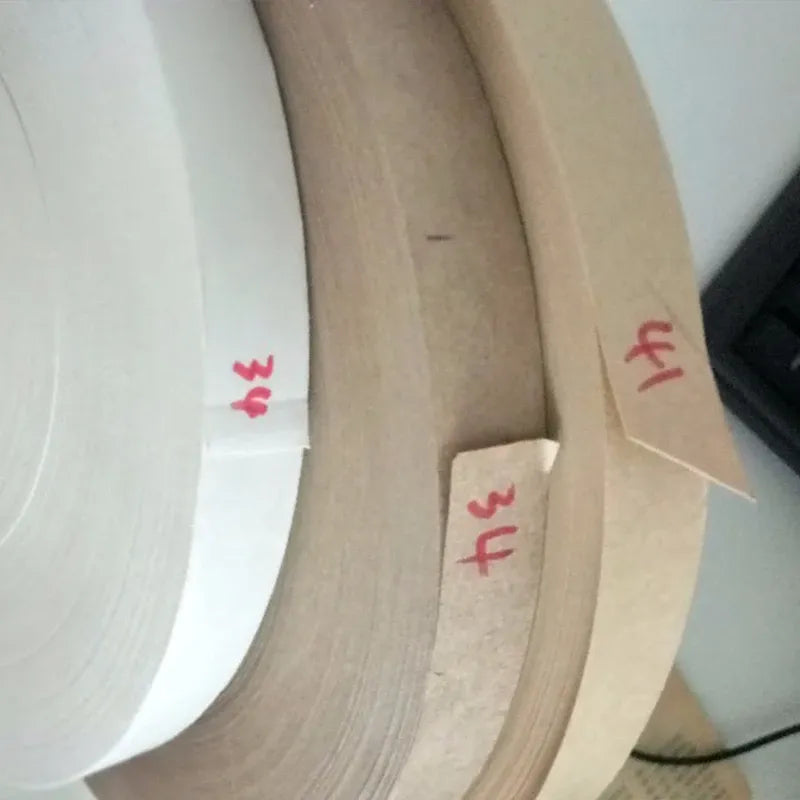 Brown and white hot melt glue tape rolls stacked, single-sided adhesive strip layers