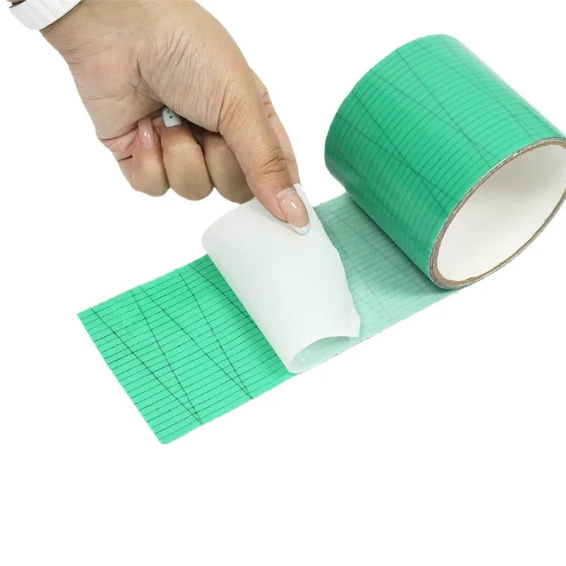 Green waterproof membrane tape being pressed by hands, showing rolled core and strip