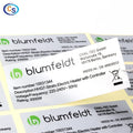 Yellow technical label stickers with printed text and warning symbols