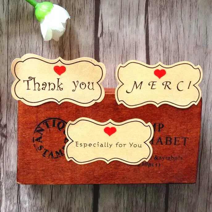 Kraft thank-you label stickers, flower shape with Thank you and MERCI text plus red hearts