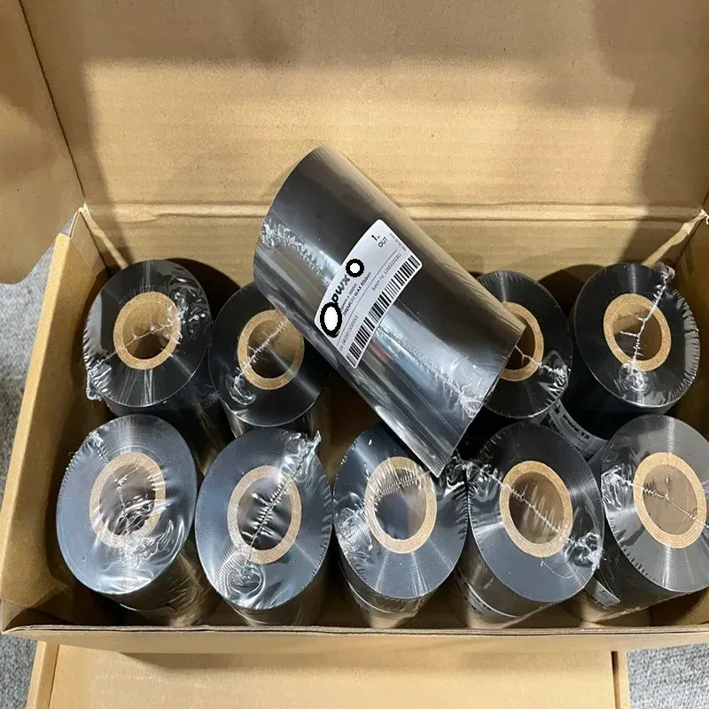 Box of black wax thermal transfer ribbon rolls with visible cardboard cores