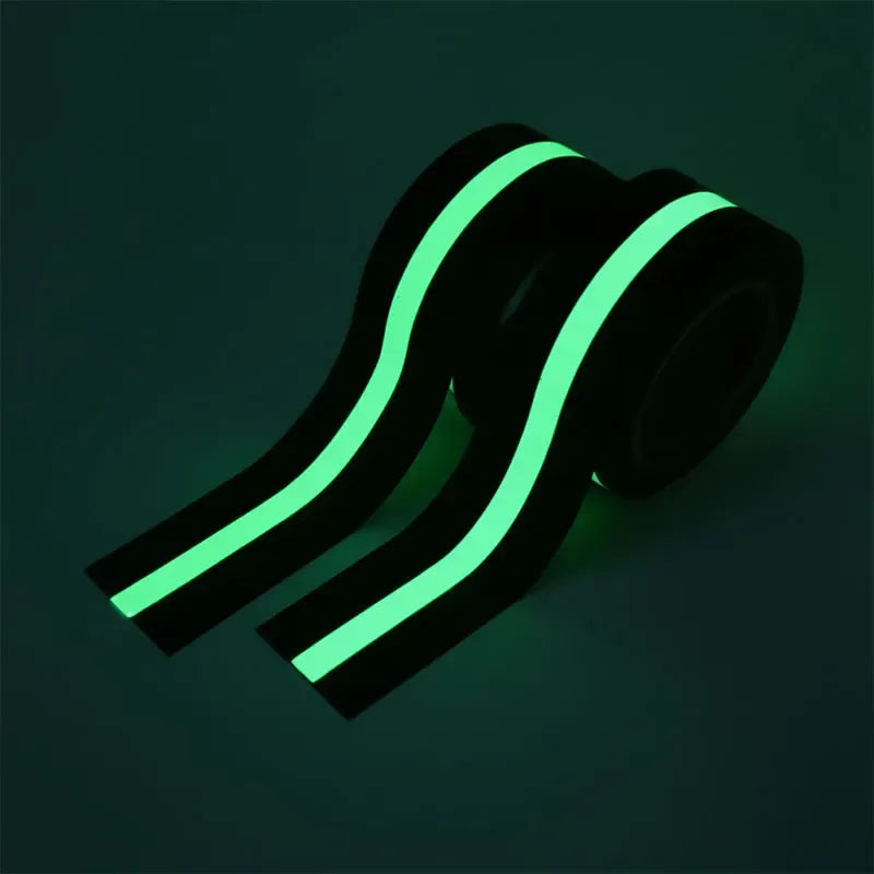 Glow-in-the-dark anti-slip tape strips with neon green glow on dark surface