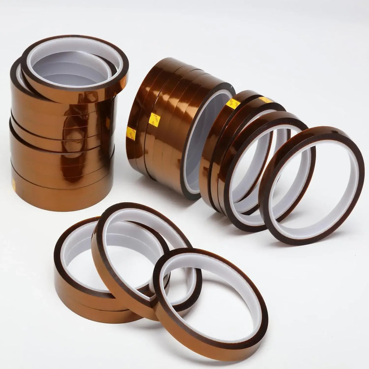 Amber polyimide Kapton tape rolls with clear backing and dark outer edge