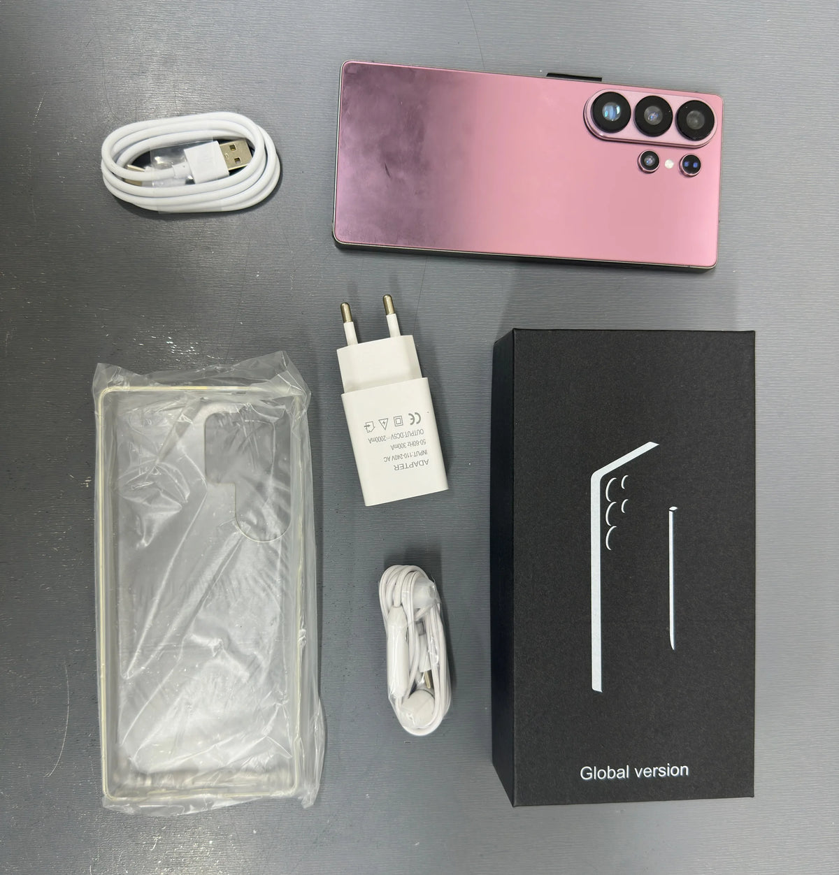 Rose gold unlocked smartphone kit with cable, charger, and Global version box