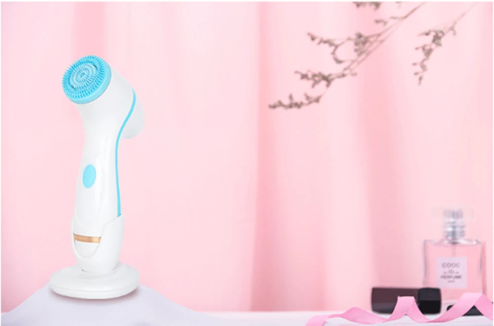 White and blue sonic facial cleansing brush with stand for deep skin exfoliation and blackhead removal.