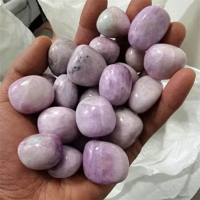Purple kunzite tumbled stones, smooth polished lavender stones in hand