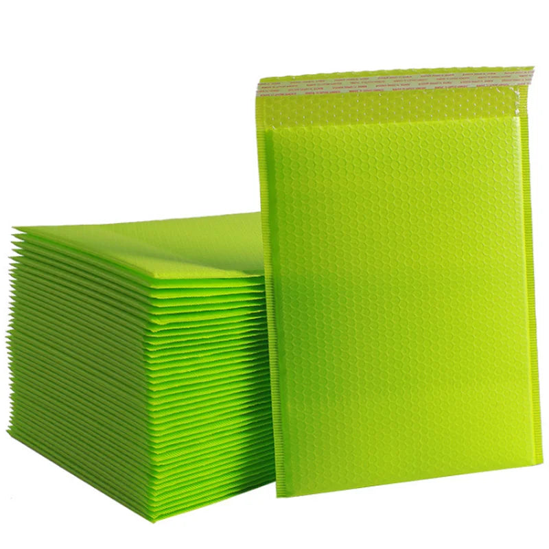 Stack of green bubble envelope bags with bubble-textured surface and sealed top